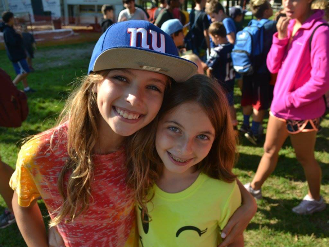 Two girls hugging and smiling.