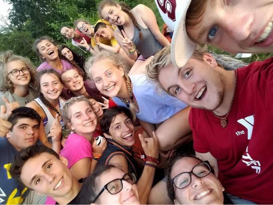 Camp counselors posing with campers.