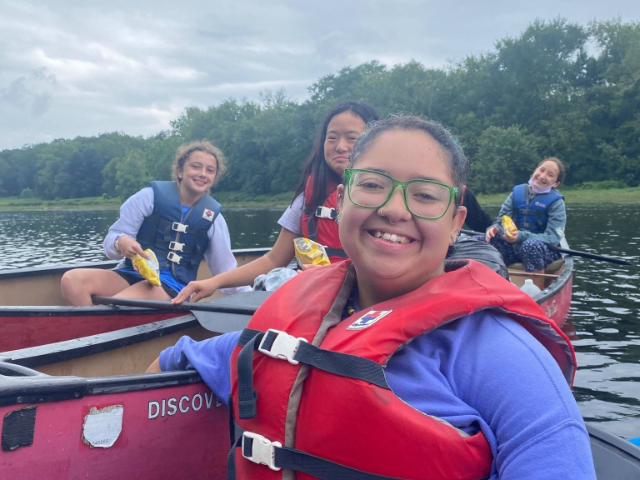 Group canoeing on river