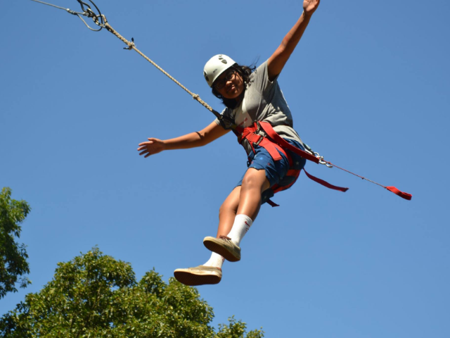 A girl swinging high in the air.